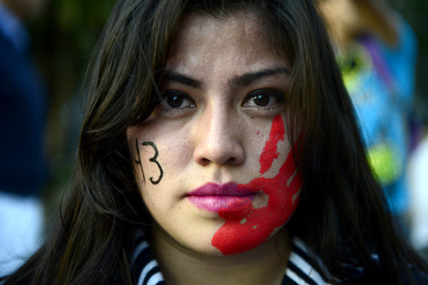 A woman participates in a protest demanding the Mexican goverment the appearence of 43 missing students in Mexico City on November 5, 2014. The arrest on the eve of Guerrero state ex-mayor and wife team suspected of masterminding the disappearance of the students last September raised hopes Wednesday that authorities can finally track them down -- dead or even alive.