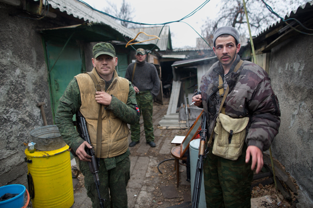 Pro-Russian gunmen pose at their house position in the North West Oktyaber neighbourhood of Donetsk on November 13, 2014, following recent days shelling near the destroyed airport in eastern Ukraine. International pressure on Russia was mounting Thursday over claims it is sending fresh military hardware into eastern Ukraine which could fuel a return to all-out conflict. 