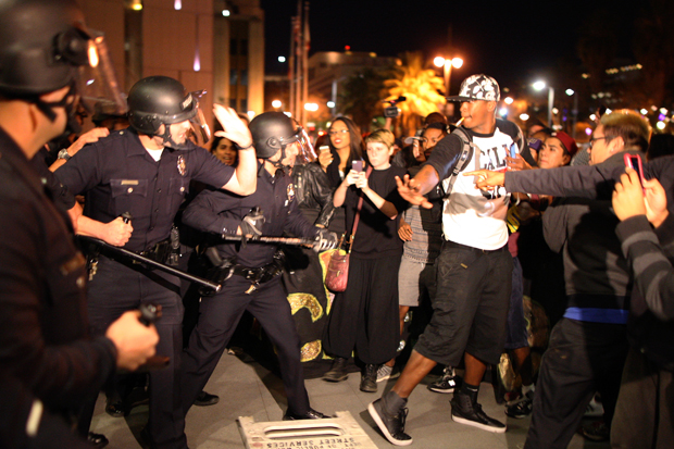 Protesters and police clash in front of LAPD Headquarters as people react to the grand jury decision not to indict a white police officer who had shot dead an unarmed black teenager in Ferguson, Missouri, in the early morning hours of November 25, 2014 in Los Angeles, California. David McNew/Getty Images