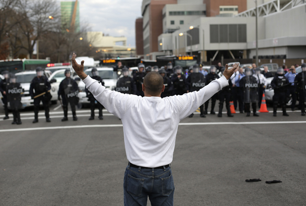 A man who randomly joined demonstrators protesting the shooting death of Michael Brown confronts police officers in riot gear November 30, 2014 in St. Louis, Missouri. 