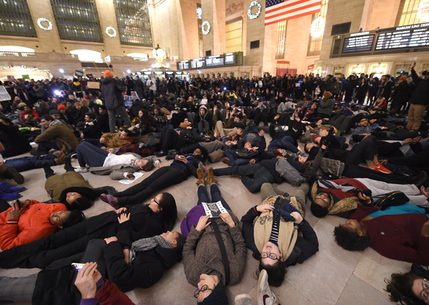 Protestors lay down in Grand Central Station during a protest on December 3, 2014 after a grand jury decided not to charge a white police officer in the choking death of Eric Garner, a black man, days after a similar decision sparked renewed unrest in Missouri. Eric Garner died after being placed in a chokehold by New York police Officer Daniel Pantaleo while being arrested on suspicion of selling untaxed cigarettes in Staten Island. 