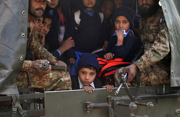 Pakistani soldiers transport rescued school children from the site of an attack by Taliban gunmen on a school in Peshawar on December 16, 2014. Taliban insurgents killed at least 130 people, most of them children, after storming an army-run school in Pakistan December 16 in one of the country's bloodiest attacks in recent years.  