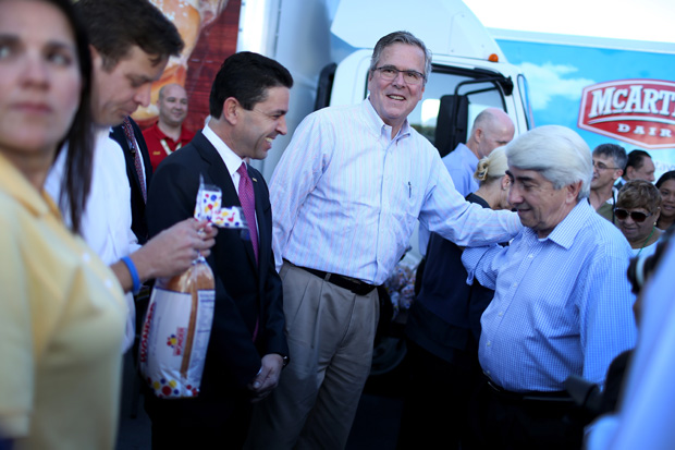 Former Florida Governor Jeb Bush hands out items for Holiday Food Baskets to those in need on December 17, 2014 in Miami, Florida. Bush recently launched two new fundraising PACs.