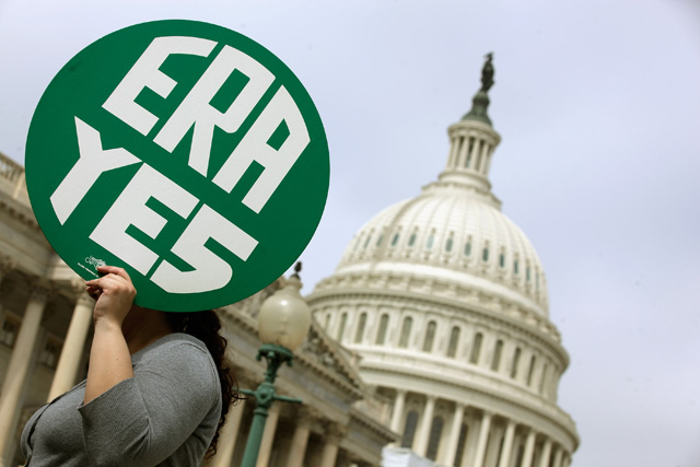 A woman hold up a sign as members of Congress and representatives of women's groups hold a rally to mark the 40th anniversary of congressional passage of the Equal Rights Amendment (ERA) outside the U.S. Capitol March 22, 2012 in Washington, DC.  Rep. Carolyn Maloney (D-NY) and Sen. Robert Menendez (D-NJ) introduced a new version of the Equal Rights Amendment last year and called for it to be passed again.  