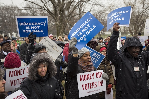 Attendees hold signs and cheer Jan. 21 during a rally calling for an end to corporate money in politics and to mark the fifth anniversary of the Supreme Court's Citizens United decision at Lafayette Square, near the White House in Washington, D.C. 
