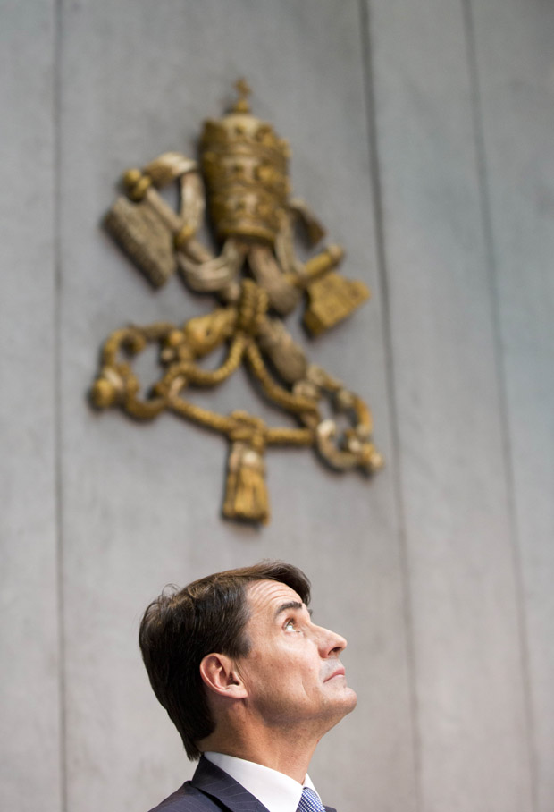 New president of the Institute of Religious Works, or IOR,  Jean-Baptiste de Franssu, left,  listens reporters' questions during a press conference in the Vatican's press room Wednesday, July 9, 2014. The Vatican has chosen a French financier as the new president of its bank, which is overhauling operations after a series of financial scandals. De Franssu, whose expertise is in investment banking, has been serving on a new Vatican economic council to help Pope Francis, whose papacy includes a mandate to heal the Vatican’s finances and modernize its financial structure, including the scandal-plagued bank.
