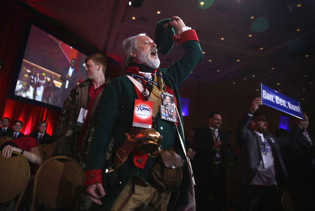 William Temple of the Golden Isles Tea Party in Georgia, dressed as Button Gwinnett, the second signer on the United States Declaration of Independence, cheers as Ben Carson speaks Feb. 26 during the 42nd annual Conservative Political Action Conference (CPAC) in National Harbor, Maryland. 