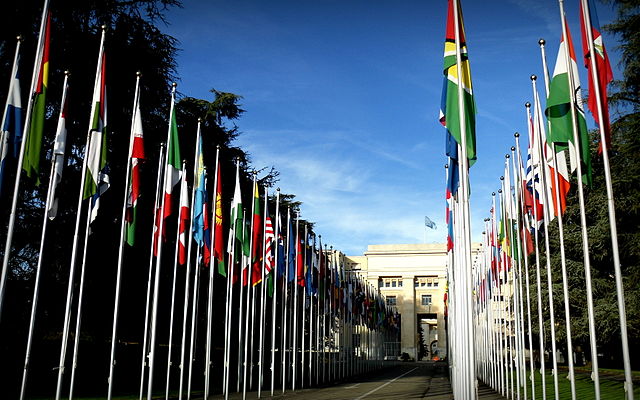 Flags of the United Nations member states in front of the Palace of Nations in Geneva, Switzerland.