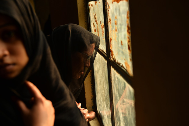 Shiite Muslim women watch an Ashura procession on November 4, 2014. 