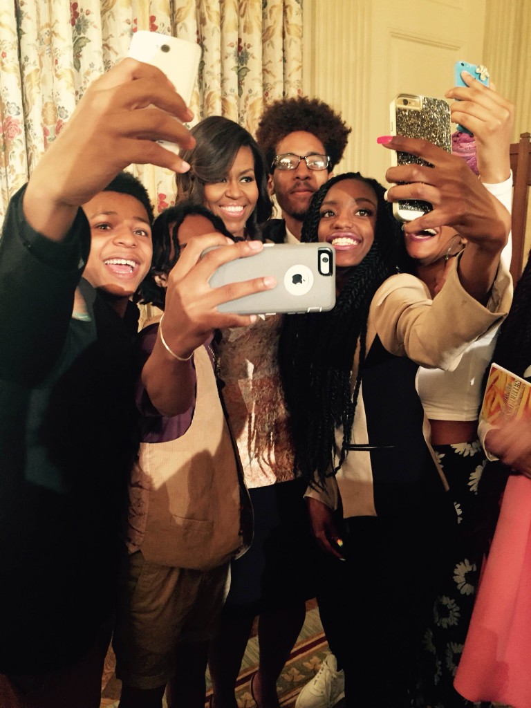 Michelle Obama takes a selfie with young poets at a White House celebration.