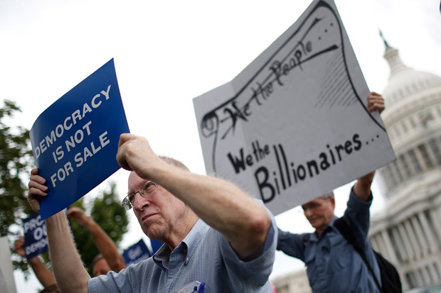 This September 2014 photo shows supporters of campaign finance reform as they listen to members of Congress discuss a reform proposal outside the U.S. Capitol in Washington, D.C.