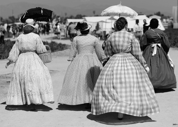 This 2012 photo shows women walking through the camp to participate during the Heritage Days and Civil War Reenactment at Pierce College Farm Center in Woodland Hills, California.