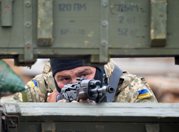 An Ukrainian serviceman mans position April 14 in Berdyanske village, west of where the use of heavy weapons has been reported on the outskirts of the strategic port city of Mariupol. 