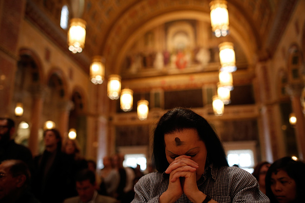 Jan Ali prays during Ash Wednesday Mass at the Cathedral of St. Matthew the Apostle in Washington, D.C.