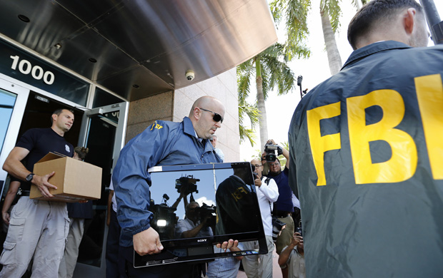 FBI agents carry boxes and computers from the headquarters of CONCACAF after it was raided May 27 in Miami Beach, Florida. The raid is part of an international investigation of FIFA. 