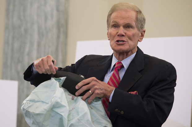 In this Nov. 2014 photo, Bill Nelson, D-FL, holds up a defective airbag during a hearing on Takata airbag defects in Washington, D.C. Takata this week doubled the number of vehicles that need to be recalled.         