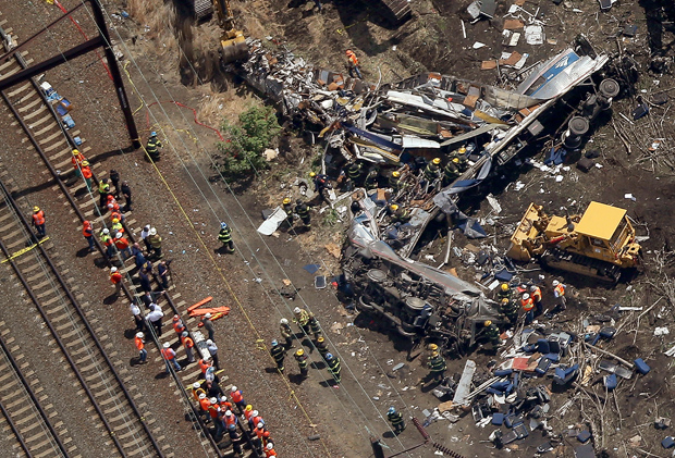 Investigators and first responders work near the wreckage of an Amtrak passenger train that derailed May 13 while carrying more than 200 passengers from Washington, D.C. to New York.