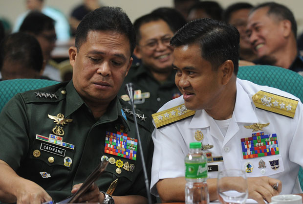 Gen. Gregorio Pio Catapang, Chief of Staff of the Armed Forces of the Philippines, talks to Vice Admiral Alexander Lopez during a Senate Inquiry of the disputed islands at the South China Sea in Manila 