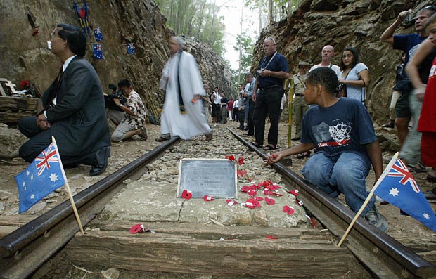 In this 2004 file photo, a pastor crosses a portion of Thailand's infamous Death Railway tracks after a special dawn vigil in Kanchanaburi.  