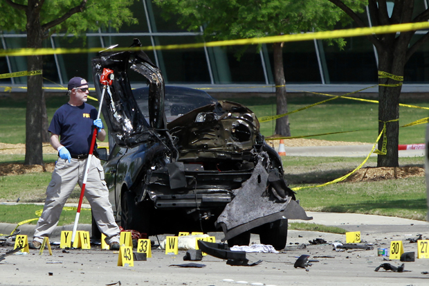 Members of the FBI Evidence Response Team investigate a crime scene May 4 outside of the Curtis Culwell Center after a shooting in Garland, Texas.