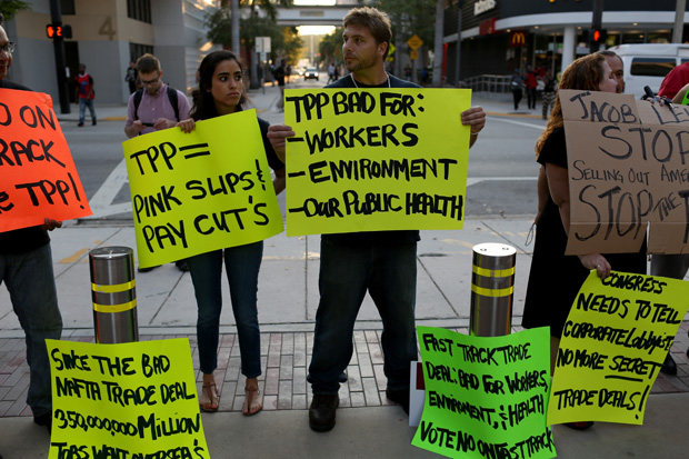This 2015 photo shows Union members and community activists protesting outside the Miami Dade College during a conference on jobs and the TPP.