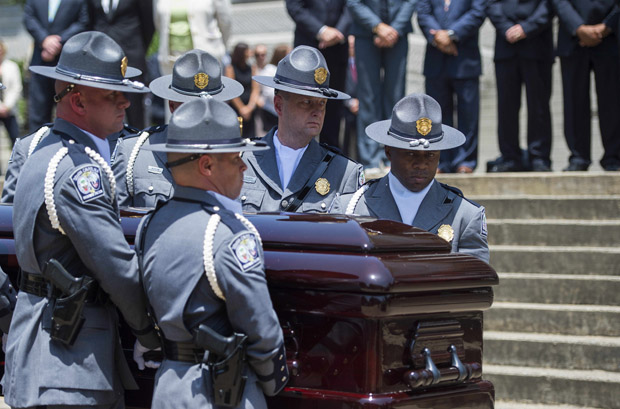 The South Carolina Highway Patrol Honor Guard arrives June 24 with the coffin of church pastor and South Carolina State Sen. Clementa Pinckney at the Statehouse in Columbia, South Carolina. 