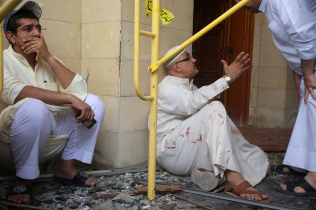 Kuwaiti men react at the site of a June 26 suicide bombing that targeted the Shiite Al-Imam al-Sadeq mosque during Friday prayers in Kuwait City. 
