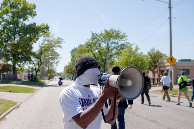 This May 23 photo shows people marching  in protest to the Cuddell Recreation Center, where Tamir Rice was killed, in reaction to Cleveland police officer Michael Brelo being acquitted of manslaughter charges.  Activists are now asking  the court to order the arrest of the officer. 