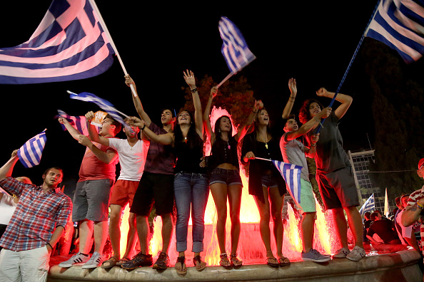 People celebrate in front of the Greek parliament July 5 as the people of Greece reject the debt bailout by creditors.