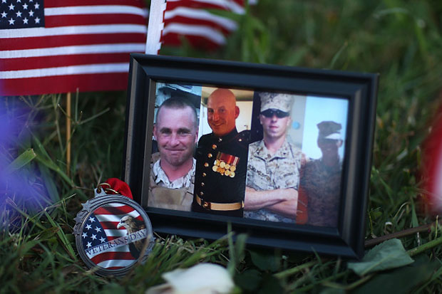 A photograph of the victims is seen among the memorial setup in front of the Armed Forces Career Center/National Guard Recruitment Office  in Chattanooga, Tennessee.  
