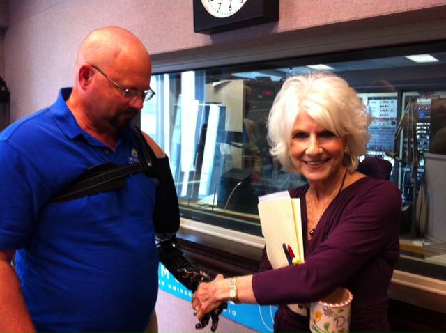 Diane shakes hands with Johnny Matheny's robust prosthetic arm. Matheny is an amputee patient working with researchers at Johns Hopkins University.