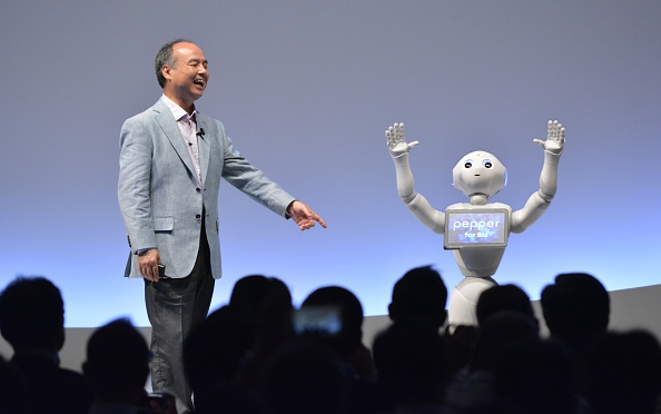 SoftBank Group representative Masayoshi Son and humanoid robot Pepper deliver a presentation at the SoftBank World 2015 in Tokyo.