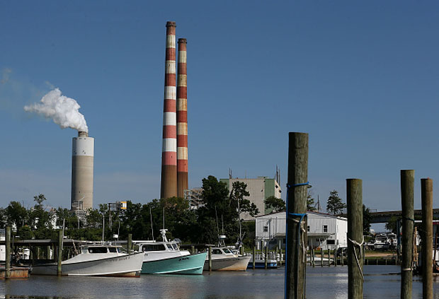 Boats are docked at the Aqualand Marina as emissions spew out of a large stack nearby at the coal-fired Morgantown Generating Station  in Newburg, Maryland.  