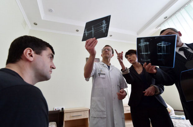 Doctors examine x-rays of a patient. 