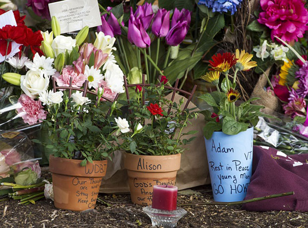 A makeshift memorial is viewed at the gate of WDBJ's television studios August 27 in Roanoke, Virginia.  The former television reporter who shot dead two journalists during a live broadcast before killing himself warned he had been a "human powder keg... just waiting to go BOOM."  