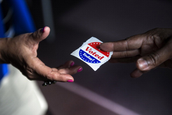 This 2012 photo shows a poll worker handing out "I Voted Today" stickers during the first day of early voting in Washington, D.C.  