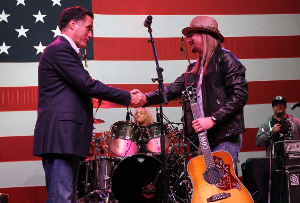 Then-Republican presidential candidate and former Massachusetts Gov. Mitt Romney (L) greets musician Kid Rock during a 2012 campaign rally at the Royal Oak Theatre  in Royal Oak, Michigan.   