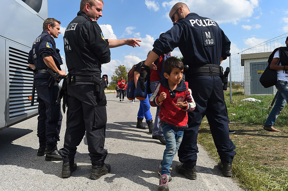 Migrants cross the border Sept. 10 between Hungary and Austria  near Nickelsdorf, Austria. 