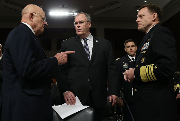 Director of National Intelligence James Clapper, left, speaks with Deputy Defense Secretary Robert Work, center, and Adm. Michael Rogers, commander of the U.S. Cyber Command prior to a Senate Armed Services Committee cybersecurity hearing on Sept. 29 on Capitol Hill.