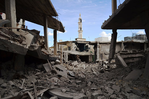 A picture taken  Sept. 30, shows buildings and a minaret damaged by Russian airtstrikes in the central Syrian town of Talbisseh in the Homs province.  