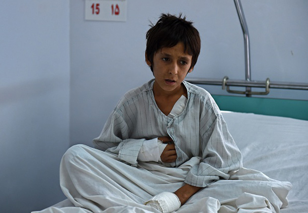 A wounded Afghan boy, who survived the U.S. airstrikes on Doctors Without Borders at the MSF Hospital in Kunduz, sits on his bed at the Italian aid organization Emergency in Kabul. 