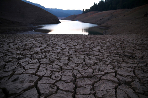 Dry cracked earth is visible on the banks of Shasta Lake at Bailey Cove in Lakehead, California. 