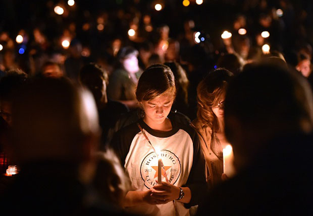 A girl prays during a vigil Oct. 1 in Roseburg, Oregon. Ten people  were killed and seven others were wounded in a shooting at a community college.