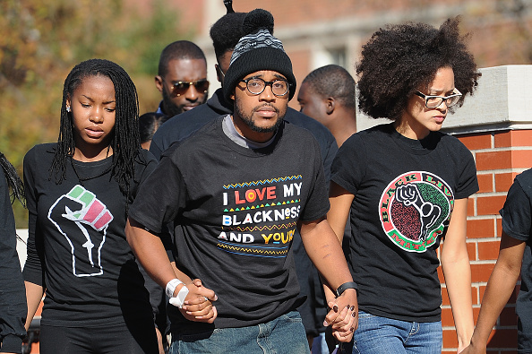 Jonathan Butler, a University of Missouri grad student who did a seven-day hunger strike, is greeted by a crowd of students Monday on campus after Tim Wolfe resigned as university president.