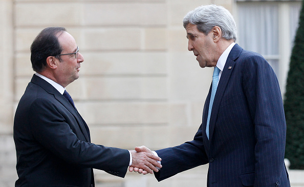 French President Francois Hollande welcomes Secretary of State John Kerry, left, prior to a meeting at the Elysee Presidential Palace in Paris on Tuesday.