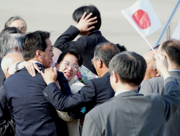 Fukie Hamamoto, abducted to North Korea in July 1978, hugs her family at Haneda Airport Oct. 15, 2002, in Tokyo upon arriving on Japanese soil for the first time in 25 years for a temporary visit. 