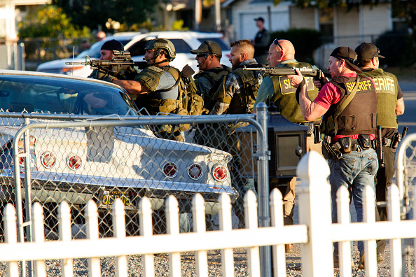 Law enforcement officers search for the suspects after the shooting Wednesday in San Bernardino, California. 