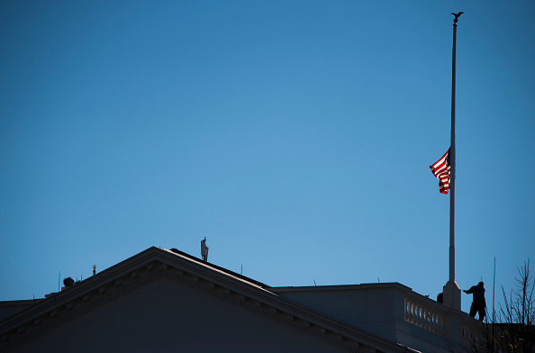 The American flag at the White House is lowered to half staff Thursday following President Obama's statement on the shootings in San Bernardino, California. 