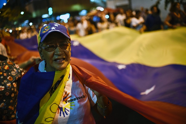 On Monday in Caracas, a Venezuelan opposition supporter celebrates the results of the country's legislative election, which took power from socialist President Nicolas Maduro. 