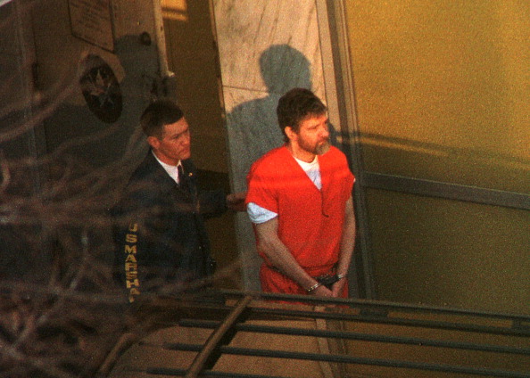 Theodore Kaczynski is led out of the federal courthouse in Sacramento, California, by a U.S. Marshal after a hearing to determine his competency on Jan. 20, 1998.